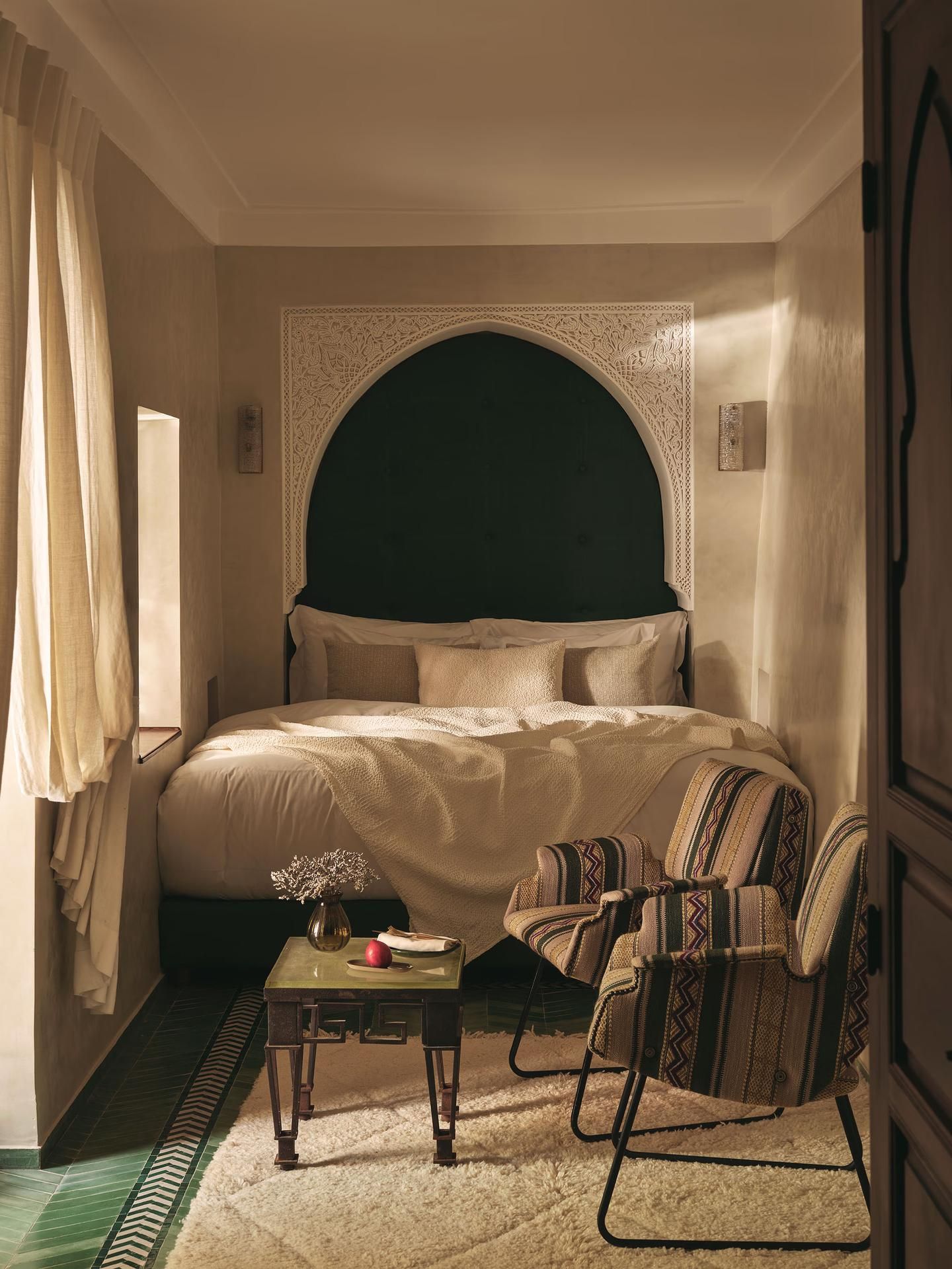 Bedroom with dark arched headboard