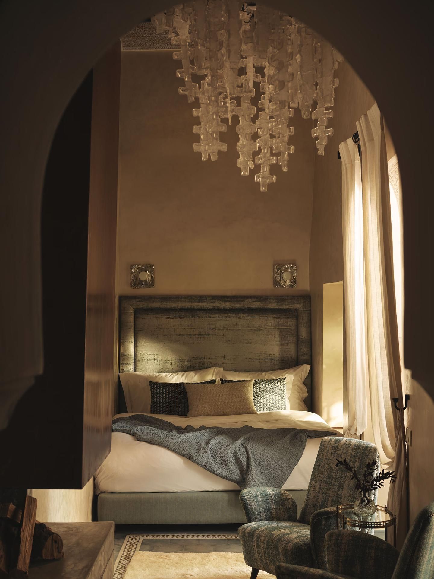 Bedroom through arch with chandelier