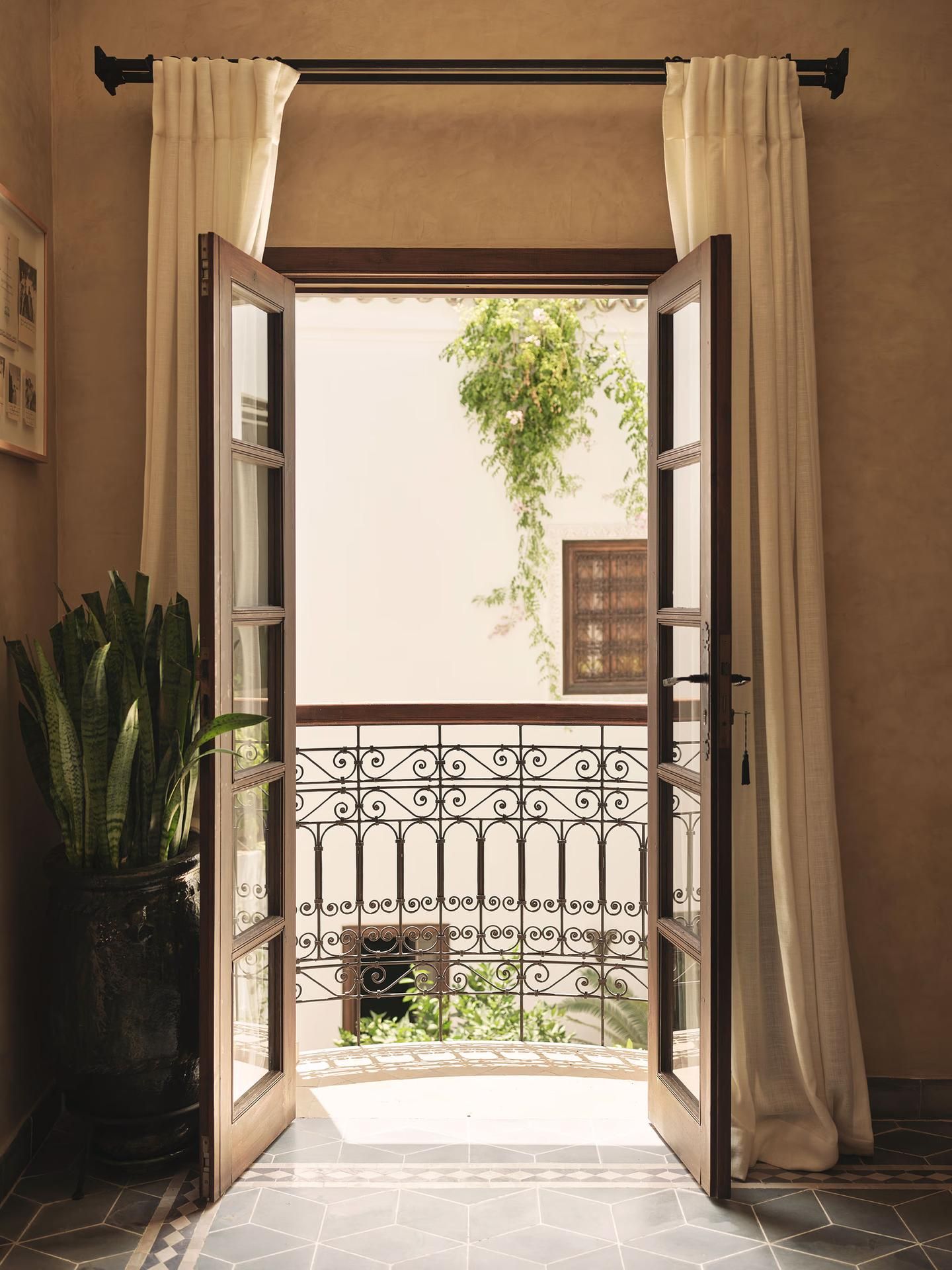 Open French doors to iron balcony