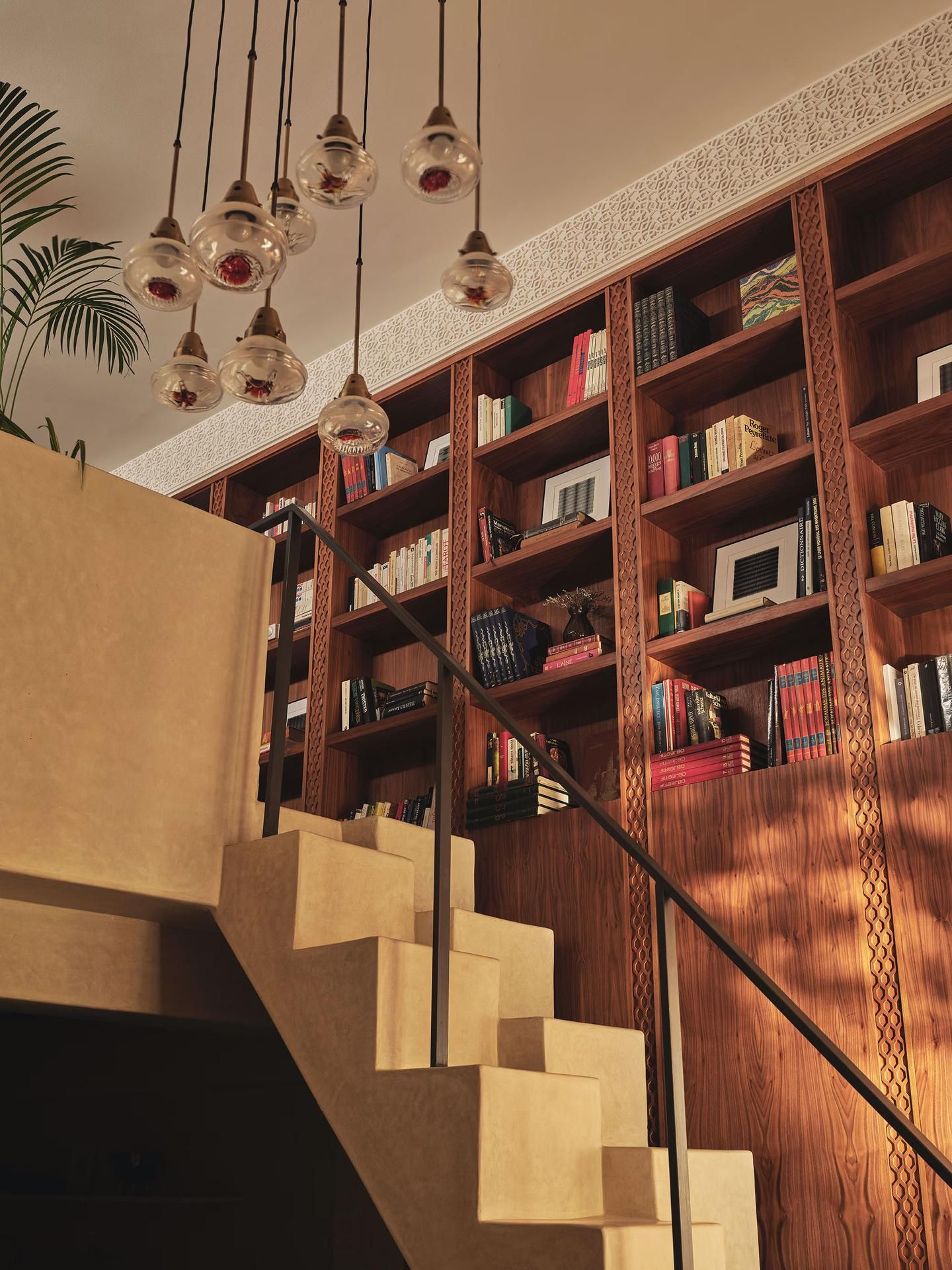 Staircase beside tall wooden bookshelf