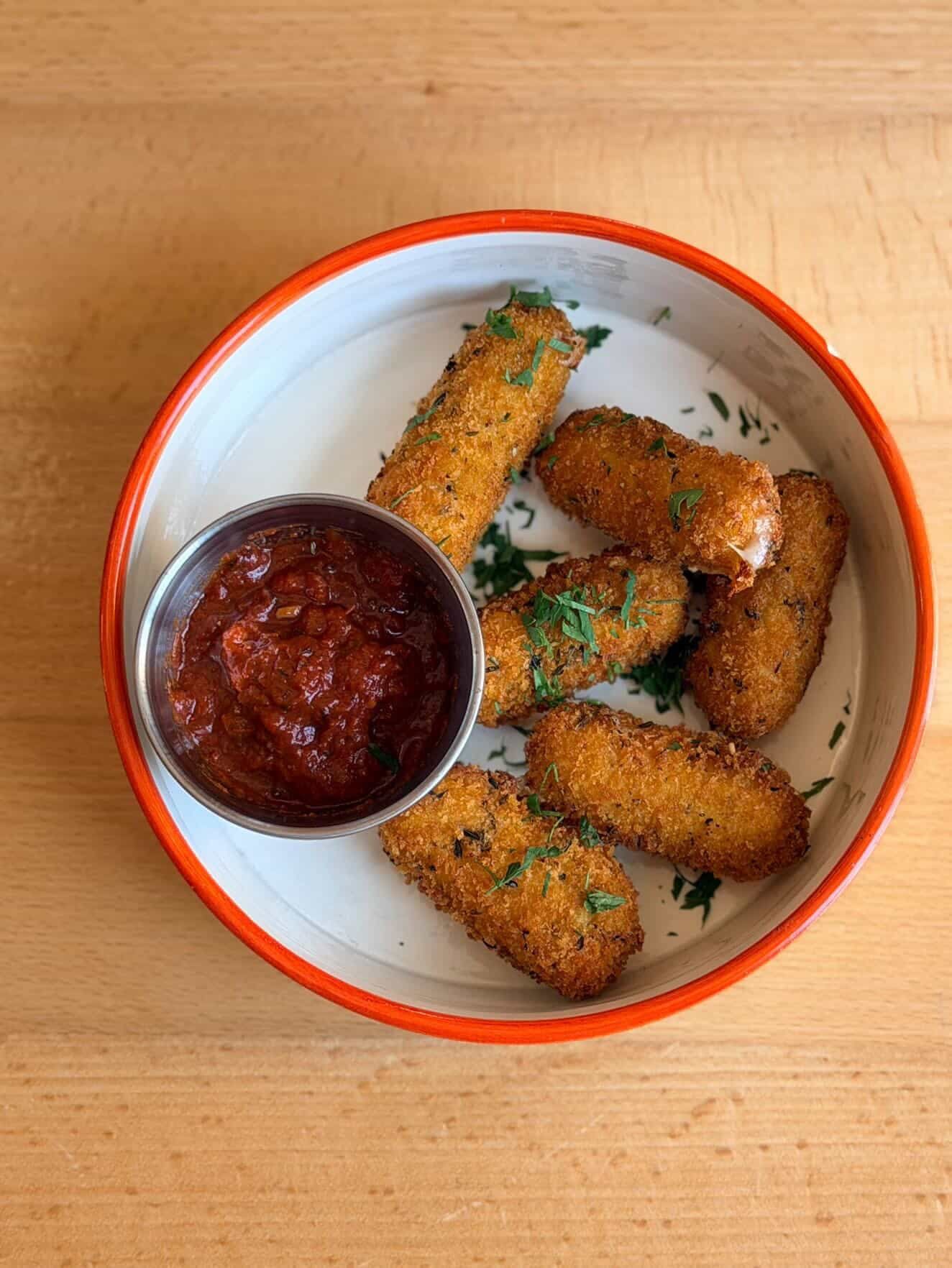 A side dish with dipping sauce at Pizzaclub