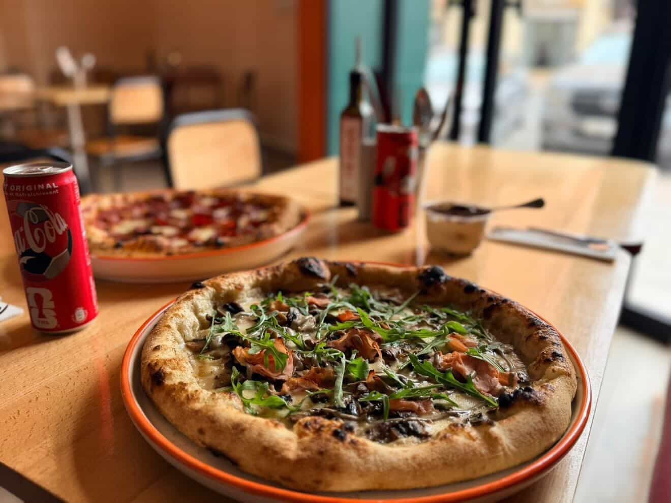 A pizza served with drinks at Pizzaclub