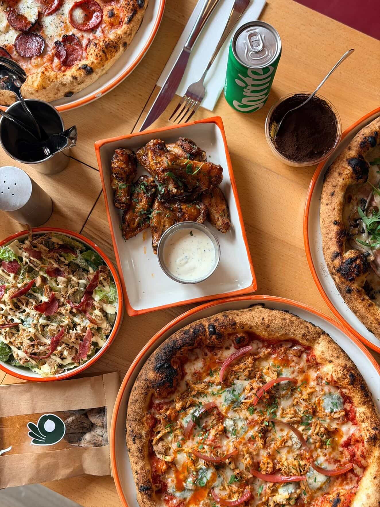 A wood-fired pizza topped with peppers at Pizzaclub