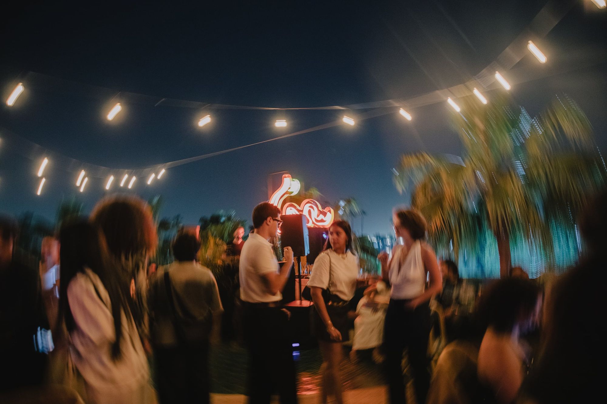 Evening on the SAMA rooftop under string lights