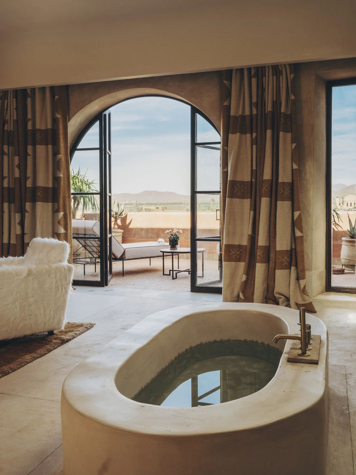 The sunken bathtub set within the suite's tadelakt walls